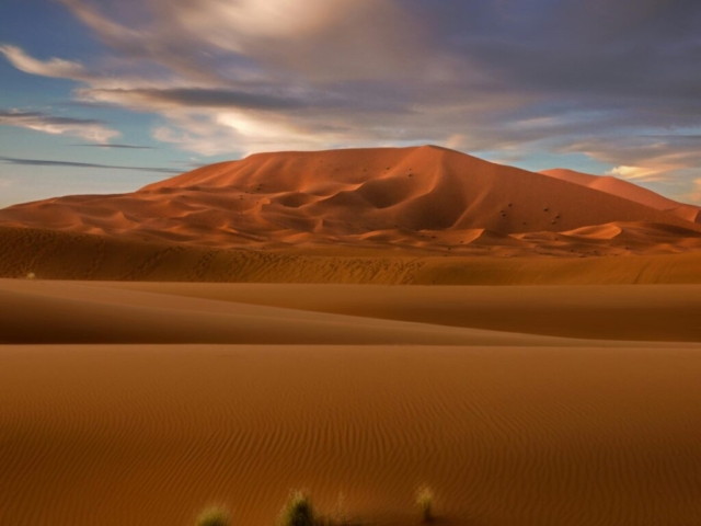 pexels-photo-3694341-3694341 Stunning view of Moroccan sand dunes under a vibrant blue sky, highlighting the beauty of the Sahara Desert.