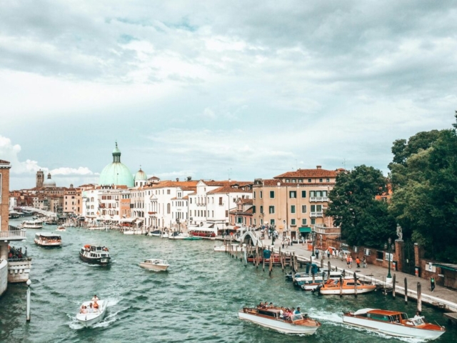 pexels-photo-3933129-3933129 High angle of boats with tourists floating in turquoise water of canal among old residential buildings